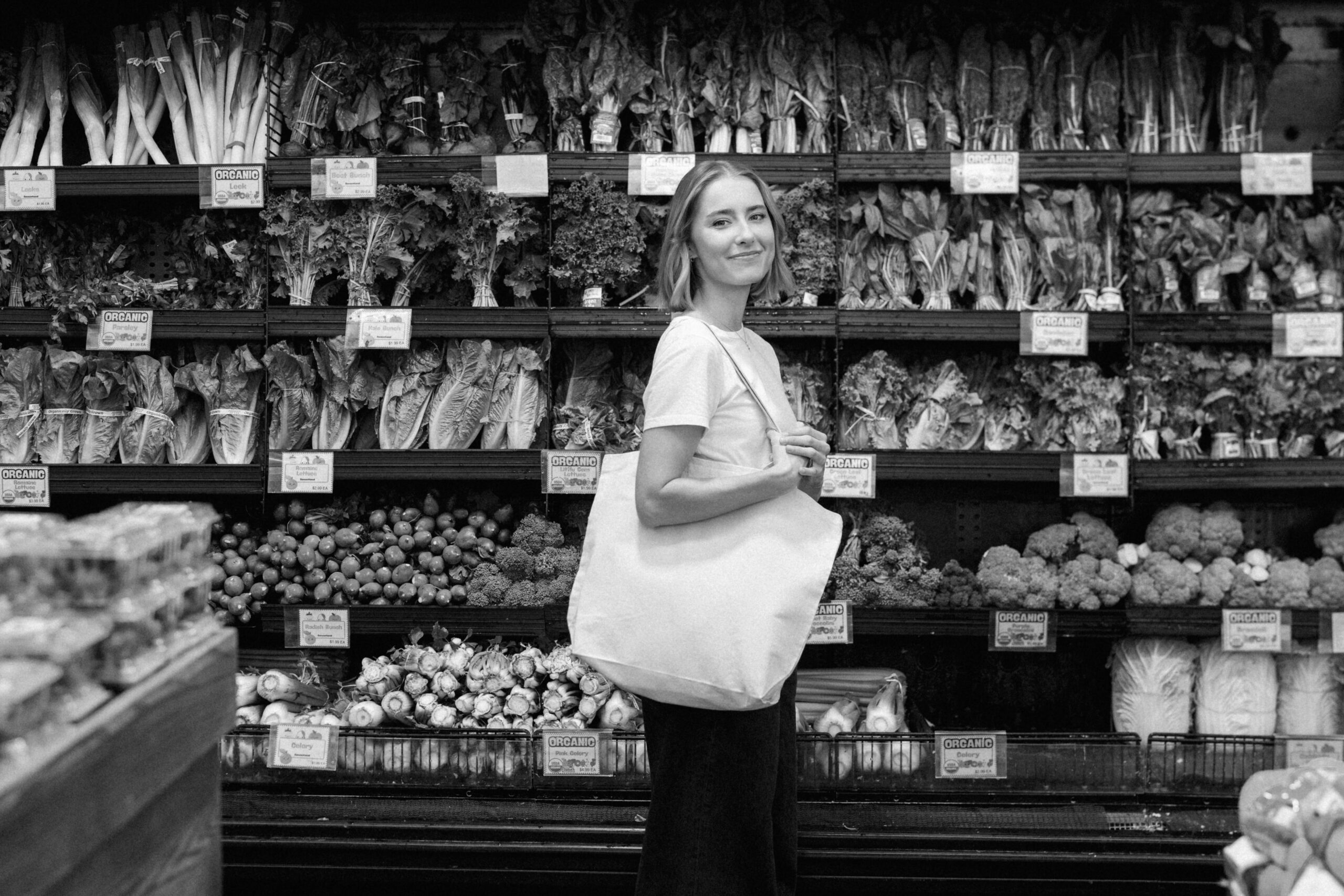a nutritionist shopping in the produce aisle in NYC for her brand photos