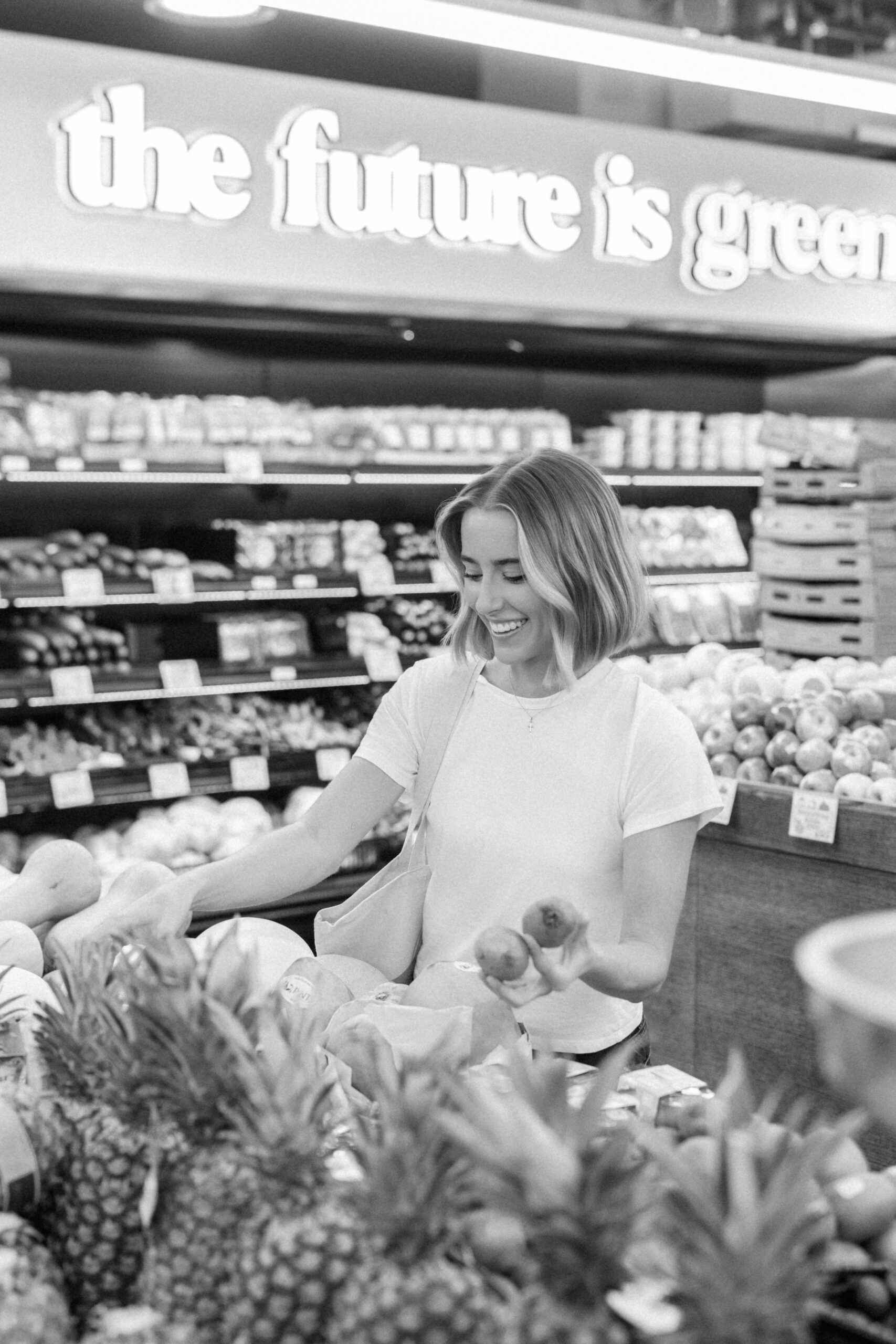 a nutritionist shopping in the produce aisle in NYC for her brand photos