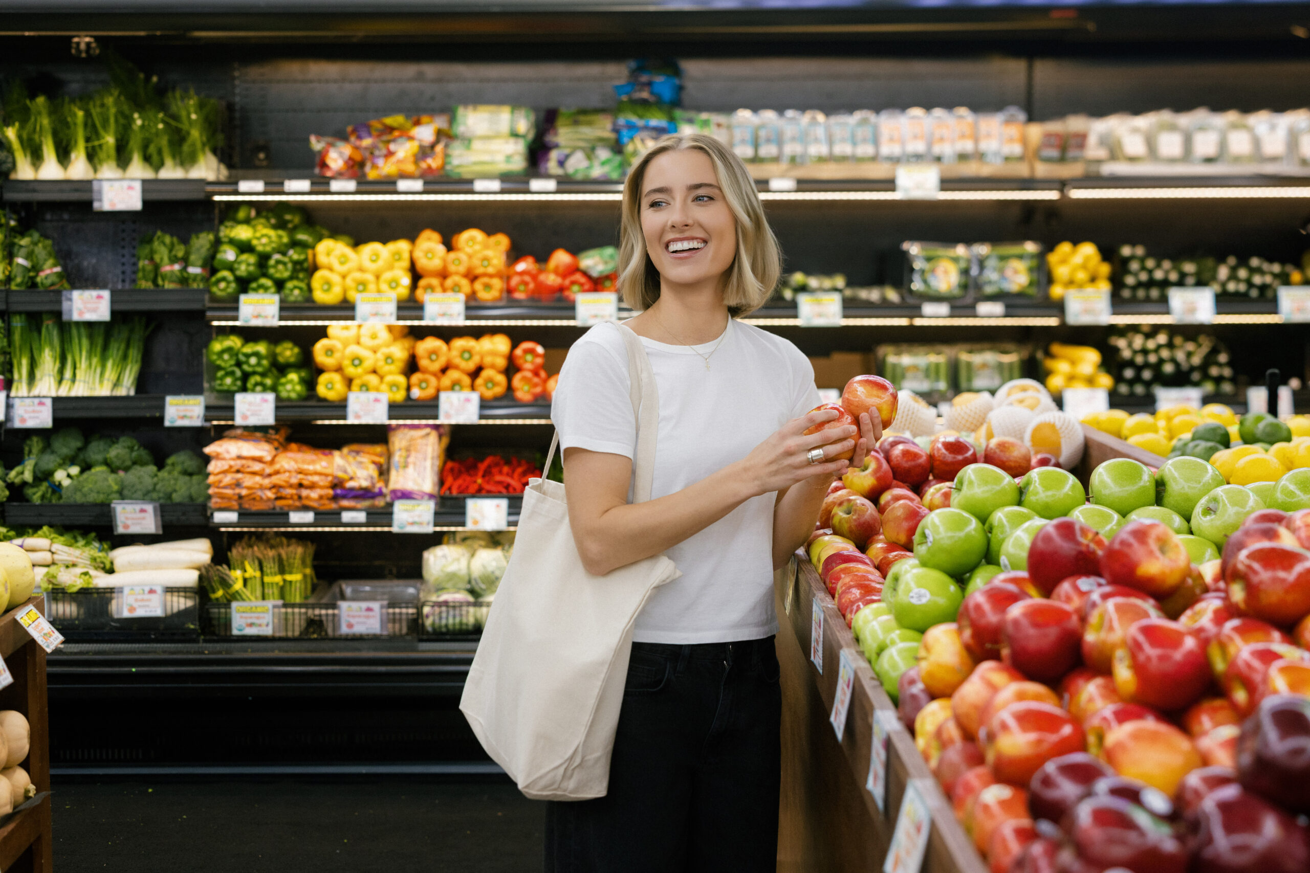 a nutritionist shopping in the produce aisle in NYC for her brand photos