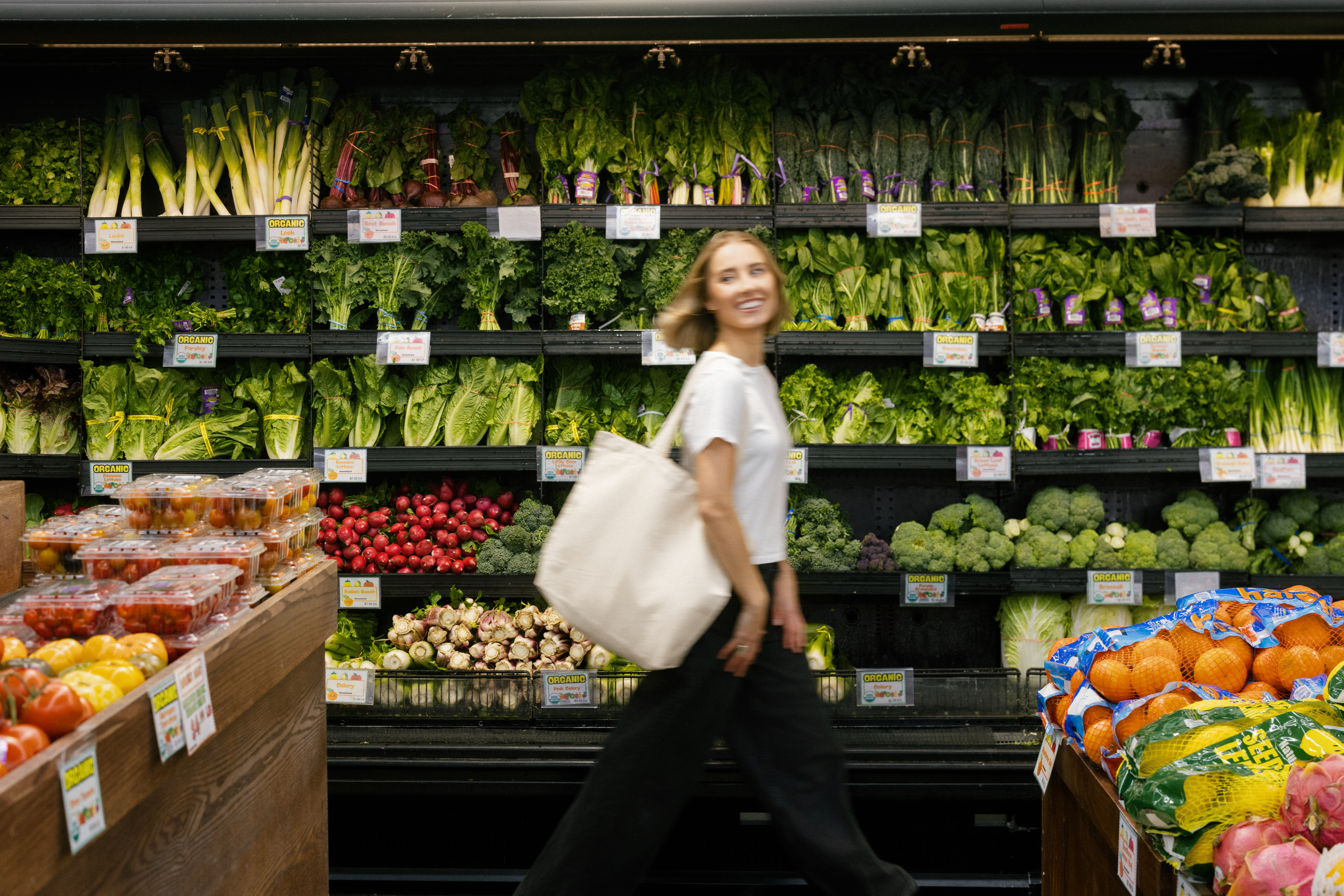 a nutritionist shopping in the produce aisle in NYC for her brand photos