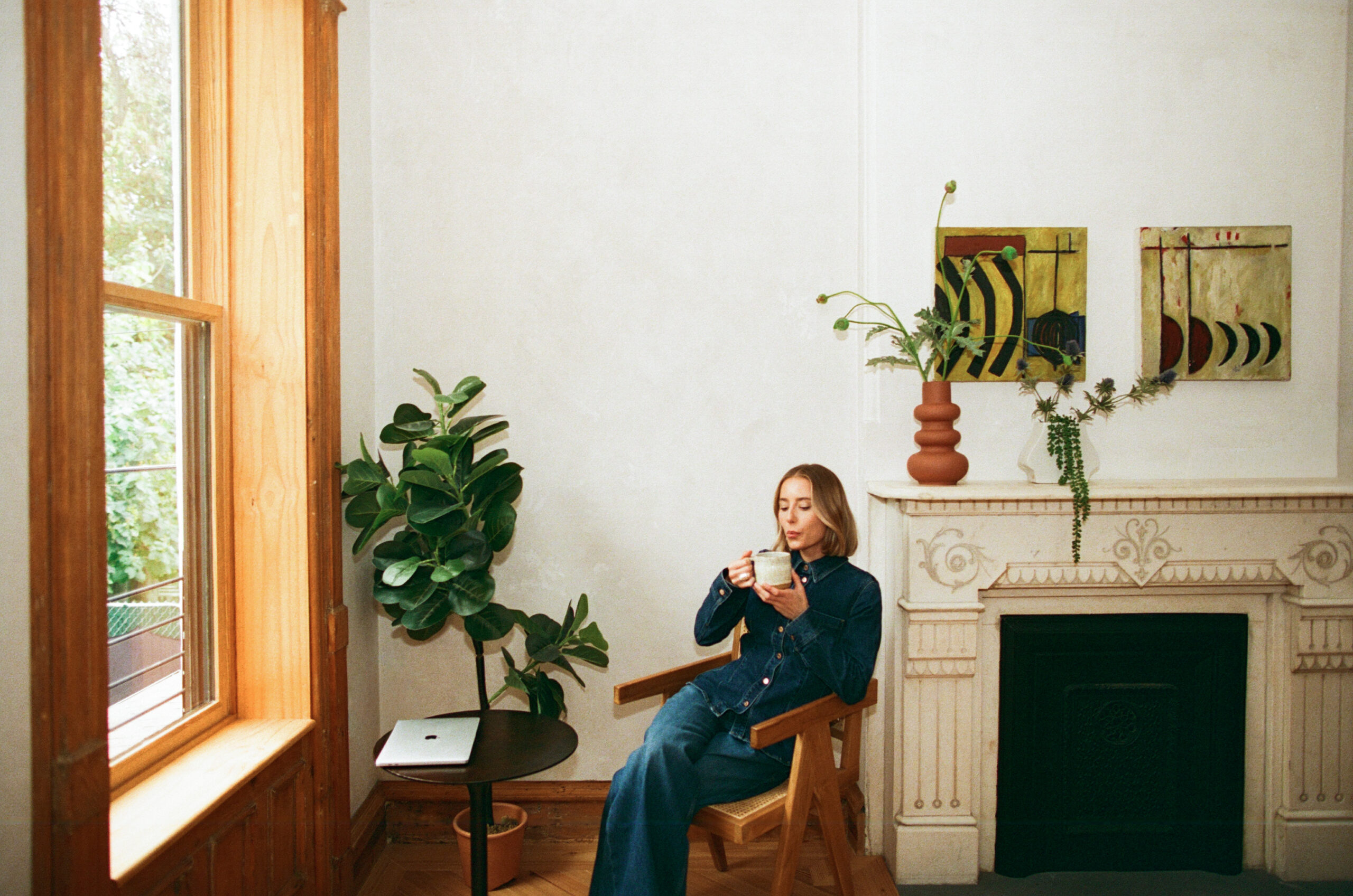 a nutritionist wearing an all denim outfit for her brand photos in NYC drinking tea