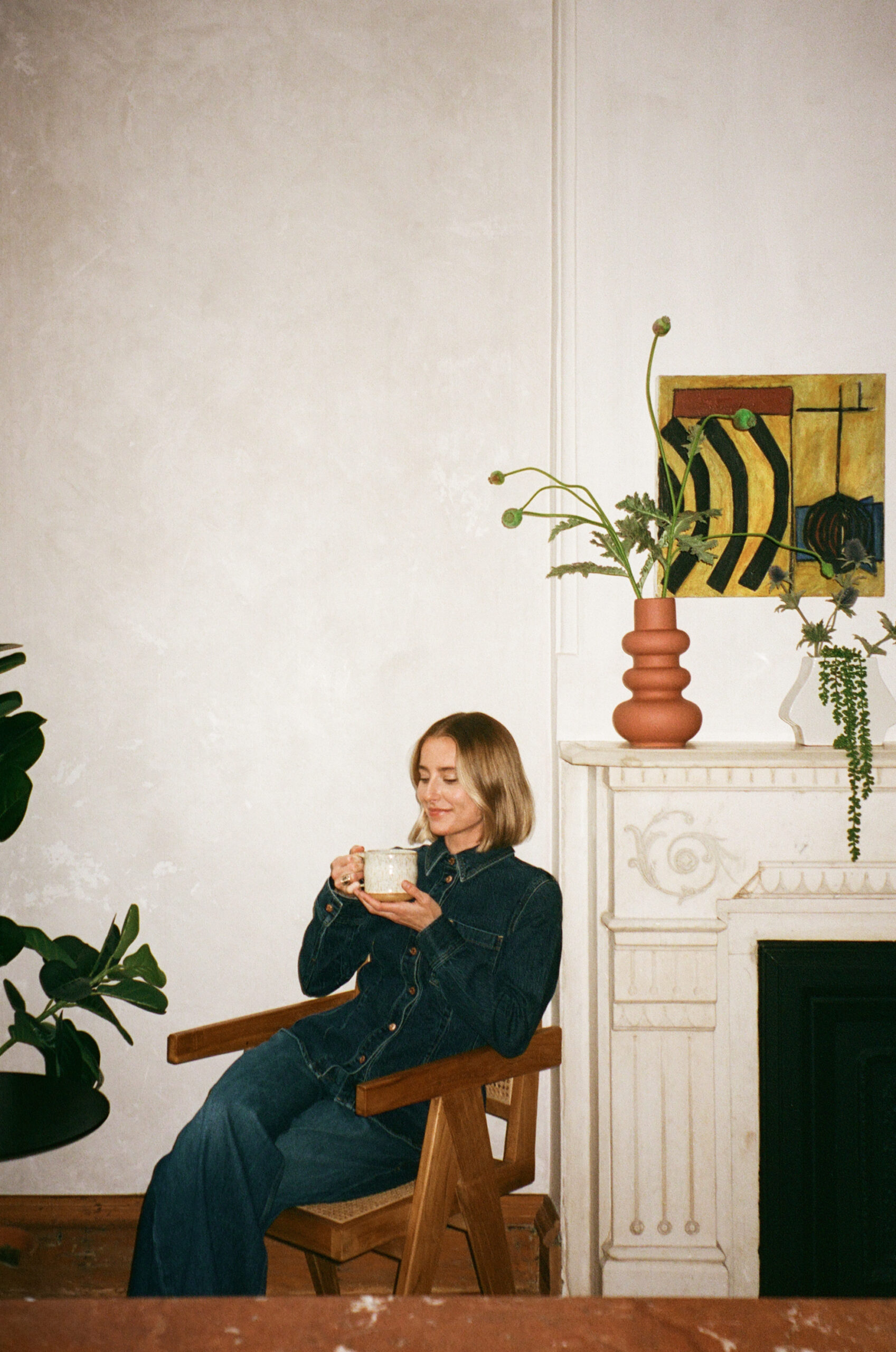 a nutritionist wearing an all denim outfit for her brand photos in NYC drinking tea