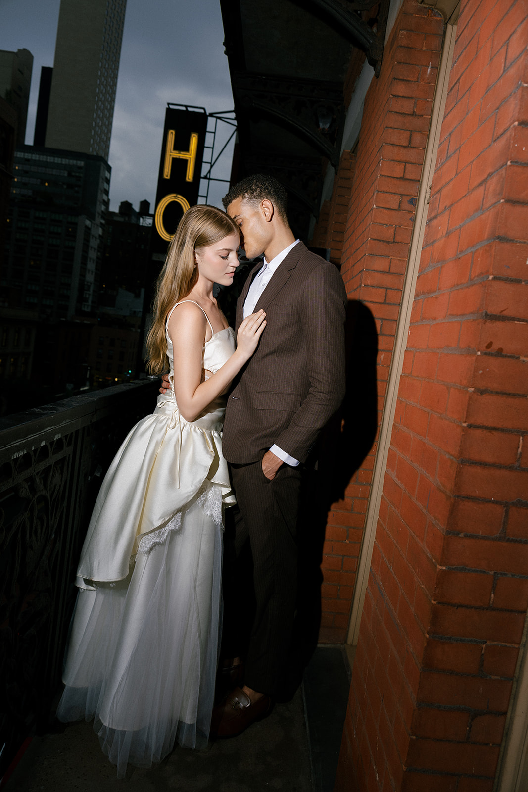 Bride and groom portraits during their welcome party on their balcony at Hotel Chelsea in NYC