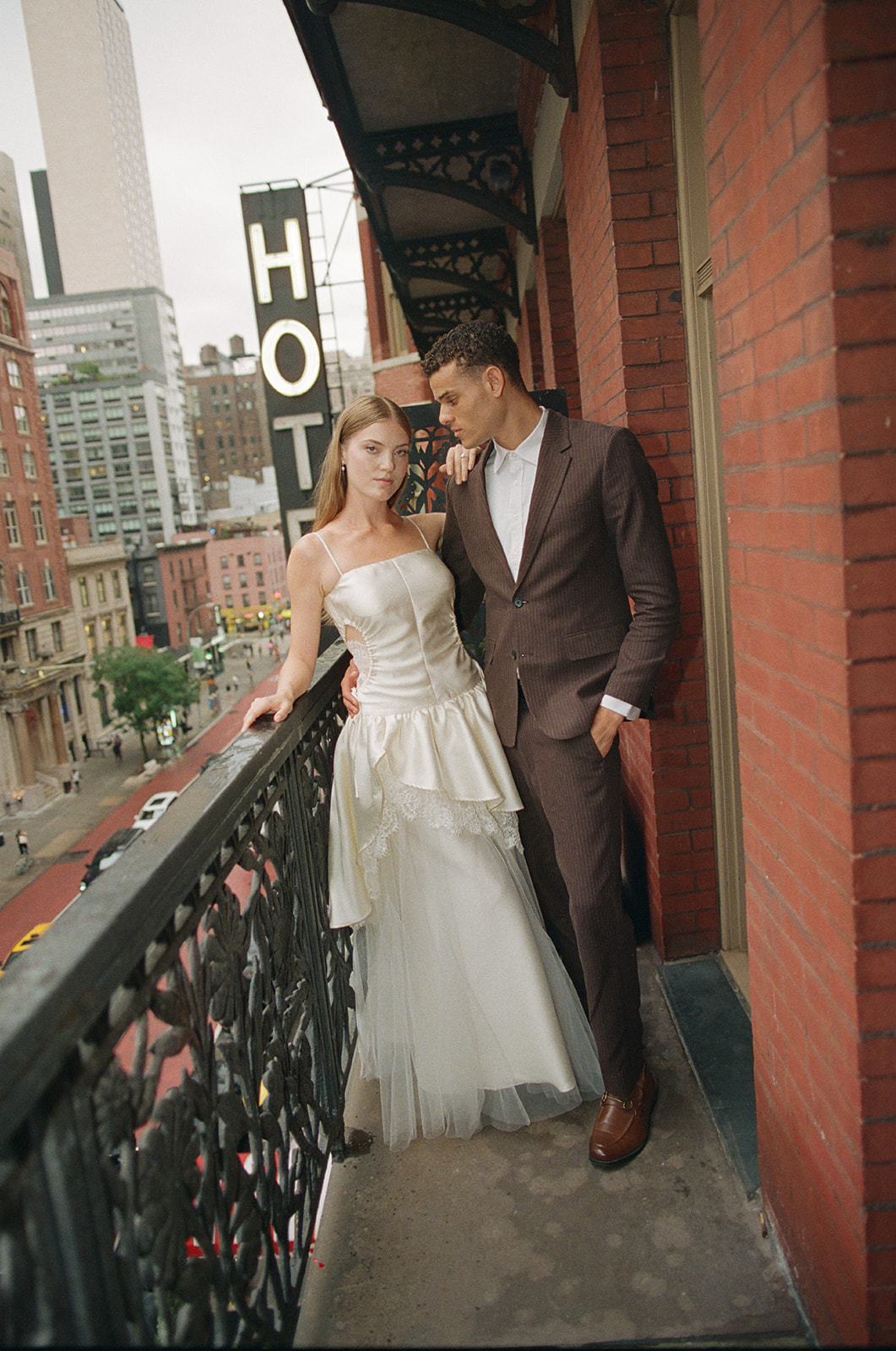 Bride and groom portraits during their welcome party on their balcony at Hotel Chelsea in NYC