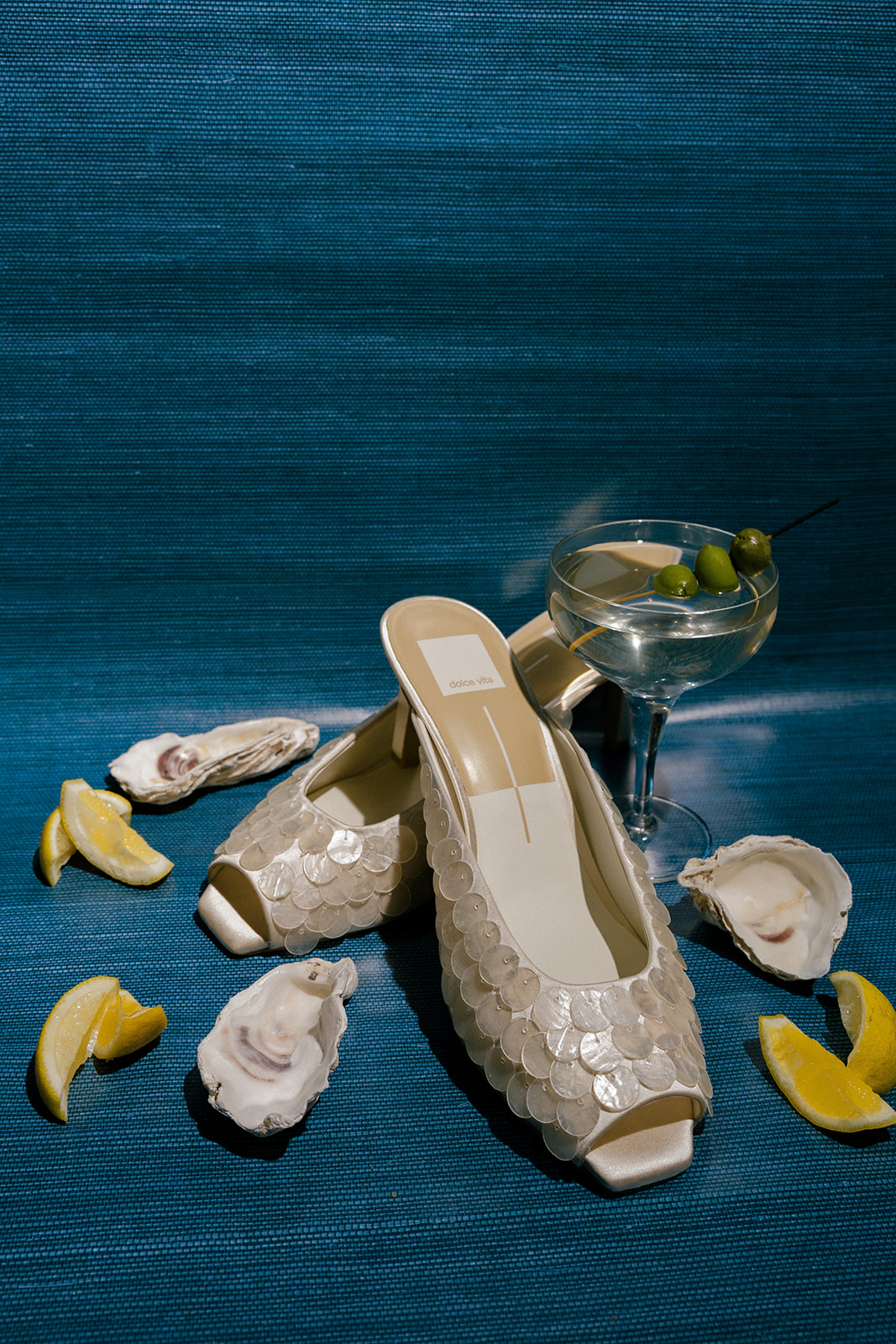 Wedding shoe details with a martini, oysters, and lemons